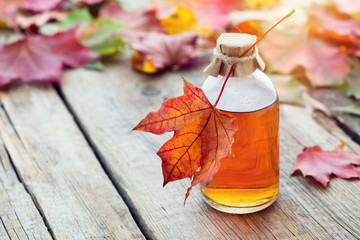 maple syrup or healthy tincture and fallen maple leaves.