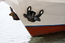 The Prow Of The Ship With Two Anchors Swims To The Shore.
