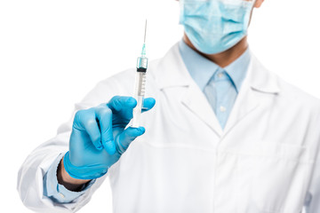 Wall Mural - partial view of young male doctor in latex gloves and medical mask holding syringe isolated on white