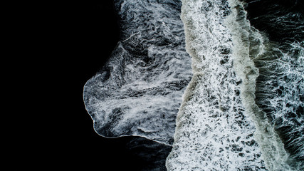 The black sand beach in Iceland. Sea aerial view and top view. Amazing nature, beautiful backgrounds and colors.