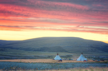 morning landscape with dwellings of nomadic reindeer herders at sunrise