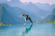 © 220 Selfmade studio - Beautiful Attractive Asian woman practice yoga Triangle pose or Utthita Trikonasana pose on the pool above the Mountain peak in the morning in front of beautiful nature views in SAPA vietnam