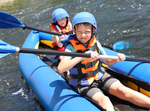 Little Children Kayaking On River. Summer Camp