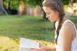 © PhotoGranary - Christian worship and praise. A young woman is reading the bible in the early morning with sun in the background.