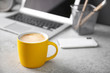 © New Africa - Yellow cup with coffee on office table. Space for text