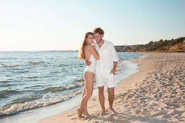 Poster - Romantic young couple spending time together on beach