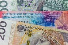 Close-up Macro Photography Of Frank And Polish Zloty. Business Money Exchange Concept Background.