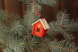 © Anna - Christmas tree with a gift house decoration on wooden background