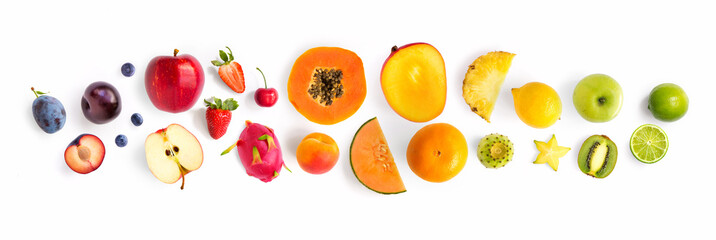 Creative layout made of fruits. Flat lay. Plum, apple, strawberry, blueberry, papaya, pineapple, lemon, orange, lime, kiwi, melon, apricot, pitaya and carambola on the white background.