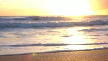 Loop Of SLOW MOTION MACRO: Pretty Glittering Ocean Waving And Washing Golden Sandy Beach
