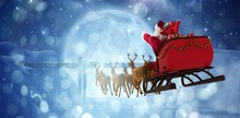 Composite Image Of Santa Claus Riding On Sleigh With Gift Box