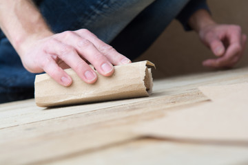 Wall Mural - Man working with sand paper in carpentry trade