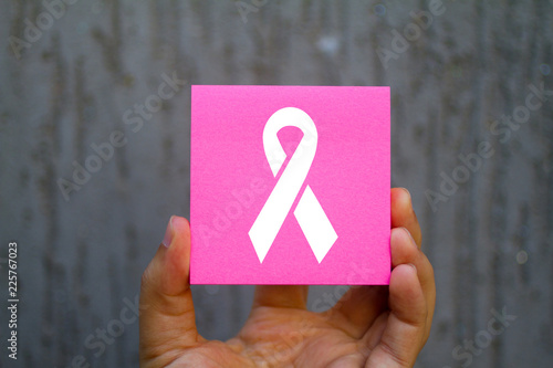 Foto Hand holding an pink Paper breast cancer's logo, Business Concept