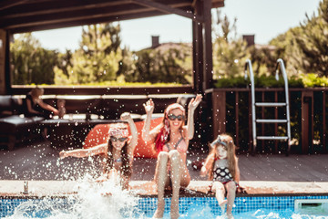 Wall Mural - Happy mother and two daughters have fun