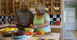 © Mark Adams - Retired black couple cooking in the kitchen