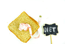 Whole Grain Bread And Measurement Tape On White Background. Good Food For Diet Concept.