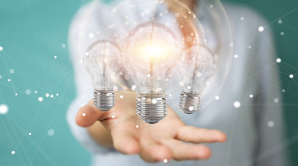 Poster - Businesswoman connecting modern lightbulbs with connections 3D rendering