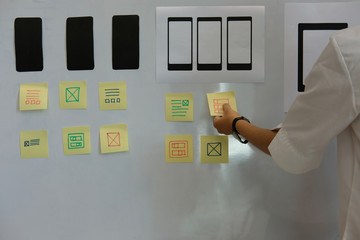 user experience ux designer designing web on smartphone layout. ui planning mobile application. deve
