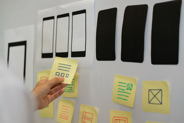 user experience ux designer designing web on smartphone layout. ui planning mobile application. deve