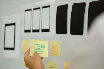 user experience ux designer designing web on smartphone layout. ui planning mobile application. deve