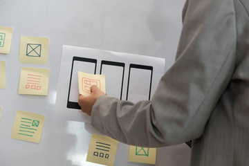 user experience ux designer designing web on smartphone layout. ui planning mobile application. deve