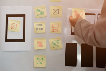 user experience ux designer designing web on smartphone layout. ui planning mobile application. deve