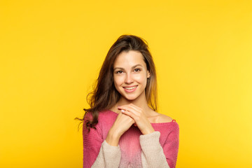 Wall Mural - happy smiling joyful delighted woman. young beautiful brown haired girl emotional portrait on yellow background. facial expression.