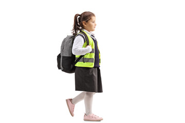 Wall Mural - Schoolgirl wearing a safety vest walking