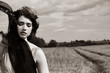 Beautiful stylish female in black and white classical portrait in field