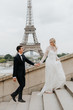 Bride and bridegroom, Eiffel Tower in background, Paris, France