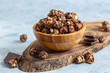 Caramel chocolate popcorn in a wooden bowl.