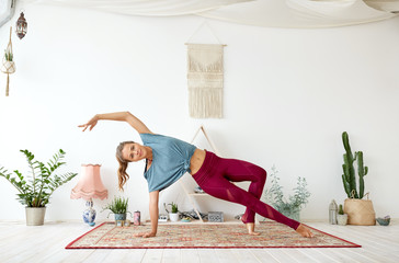 Wall Mural - fitness, people and healthy lifestyle concept - young woman doing yoga at studio