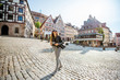 Young woman tourist walking on the beautiful city square in the old town of Nurnberg, Germany