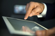 © New Africa - Businessman using digital tablet at workplace, closeup of hand. Mockup for design