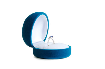 Wedding ring in a blue velvet box. White isolate.