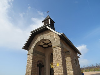 chapel in vineyards, blue spring sky, clouds