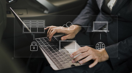 Hands working on a laptop cloud network graphic overlay