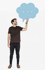 Wall Mural - Cheerful man holding a blank speech bubble symbol