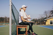 © Maskot - Senior woman resting after tennis game