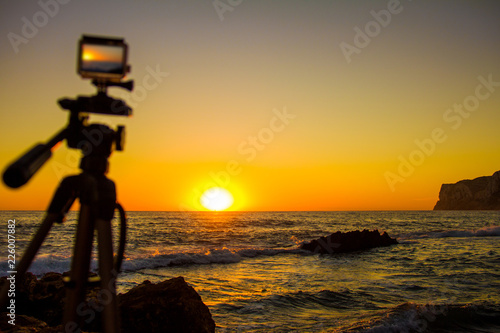 Fotografie, Obraz Action camera capturing a sunrise on "Las Rotas" beach in Denia, Spain