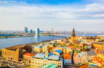 Wall Mural - Panoramic view of old town with bright colorful houses and Riga Dome Cathedral, bridge over Dvina river in Riga, Latvia. Beautiful cityscape, top view.