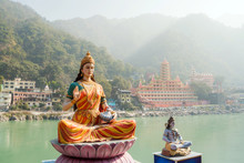 Statue Of Sitting Goddess Parvati And Statue Shiva On The Riverbank Of Ganga In Rishikesh.
