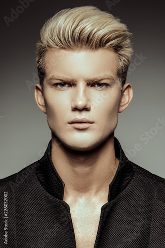 Handsome Stripped Blonde Male Model Wearing Black Suit On White