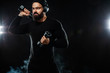 © Mike Orlov - Muscular young fitness sports man, athlete workout with dumbbell and headphones in gym