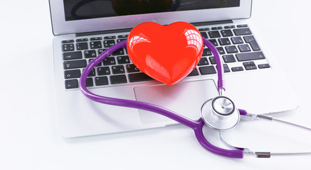 Stethoscope lying on a laptop keyboard in a concept of online m