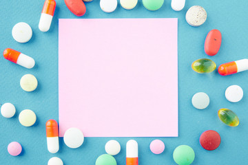 Sticker - Pills are scattered over a blue background