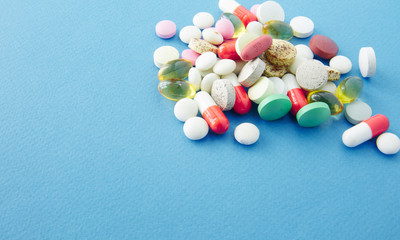 Canvas Print - Pills are scattered over a blue background