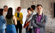 © luckybusiness - Portrait of businessman with colleagues.