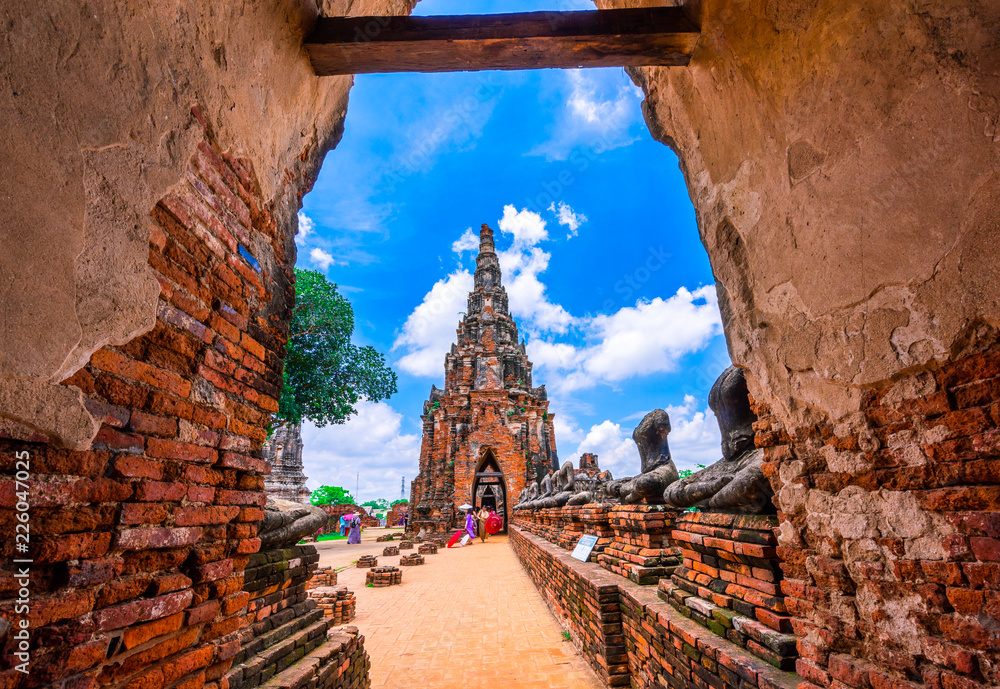 Tourists visit the ancient temple Wat Chaiwatthanaram located at Ayutthaya, Thailand. - obrazy, fototapety, plakaty 