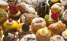 Many Kind Of Little Pastries With Cream, Chocolate And Fruit
